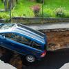 Hole almost swallows car on south London street