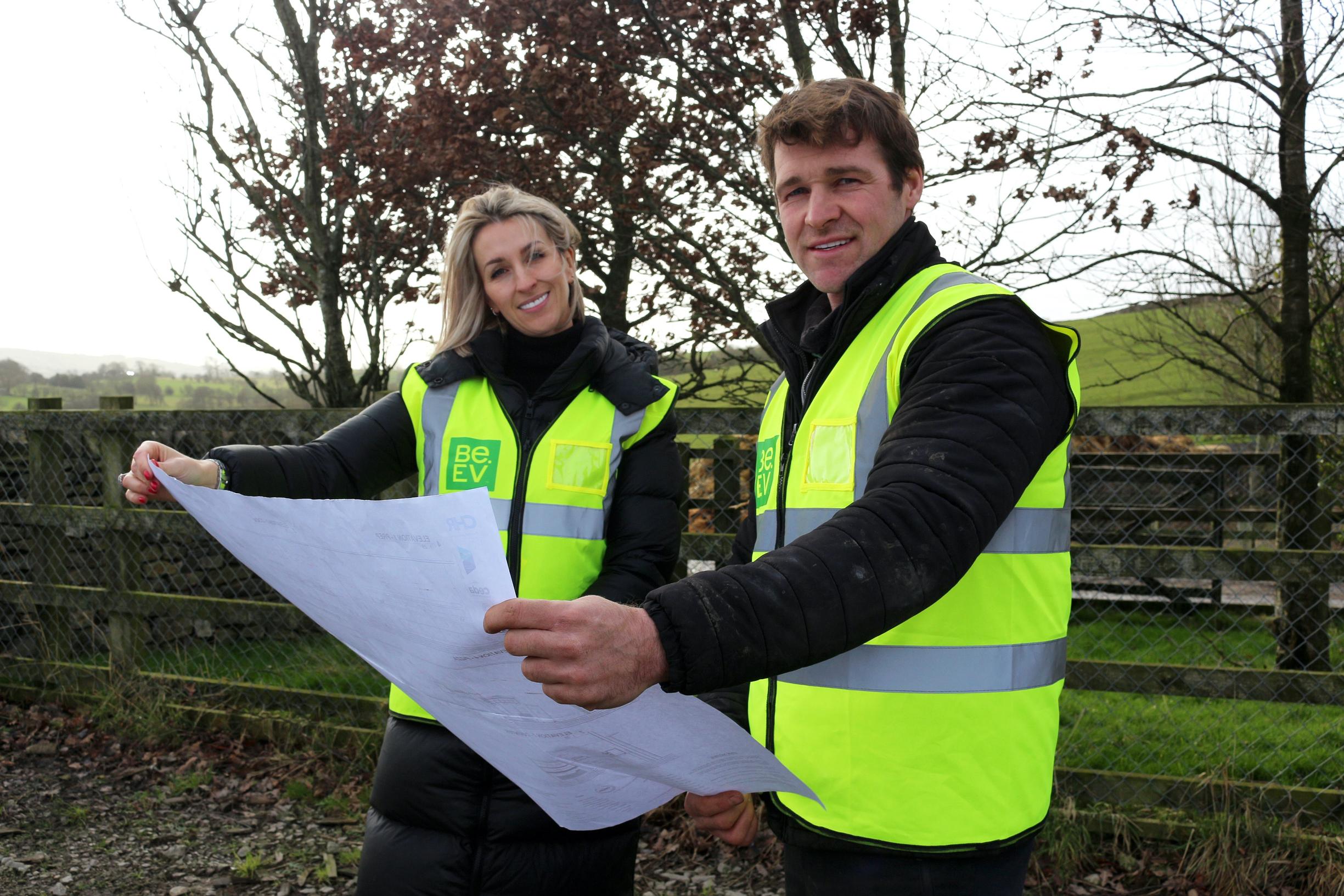 Emma and Chris Harrison look over plans for their new electric vehicle charging hub